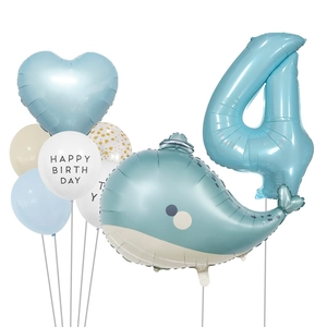 Detail of blue whale and number 4 foil balloons for a child's birthday celebration
