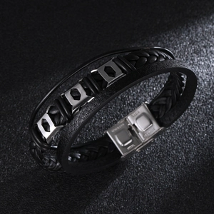Detail of multi-layer black braided leather bracelet with stainless steel magnetic clasp