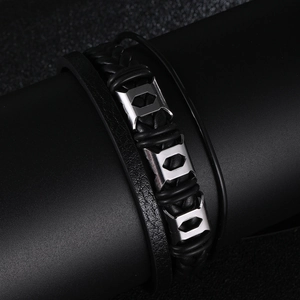 Close-up of men's multi-layer black braided leather bracelet with silver hexagonal metal sliders
