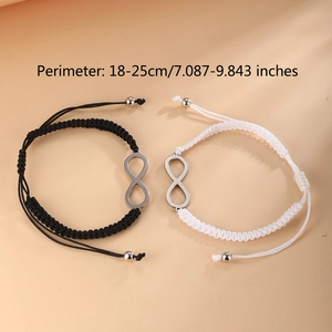 Detail showing hand-woven infinity bracelets in black and white with 18-25cm adjustment