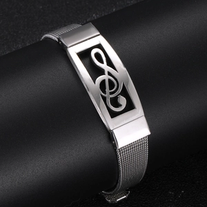 Detailed close-up of silver mesh bracelet with hollowed treble clef musical note plate