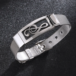 Close-up of silver mesh band bracelet featuring a polished G-clef musical note design