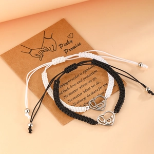 Handmade woven heart charm bracelets in black and white with adjustable cord for couples