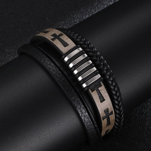 Detailed view of multilayer leather bracelet with cross print and silver metal accents