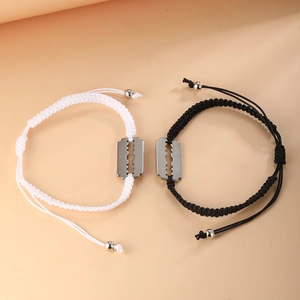 Matching pair of black and white woven rope bracelets with unique stainless steel blade charms