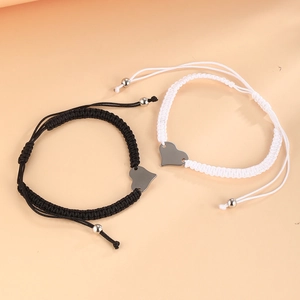 Detail of adjustable heart charm braided bracelets with polished stainless steel tags