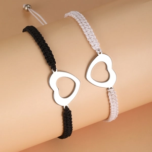 Matching woven couple bracelets with hollow heart charms in black and white styles