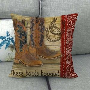 Detail of vintage cowboy boots and paisley print on linen pillowcase over sofa