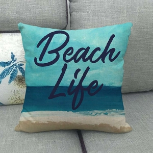 Linen blend square pillow with beach landscape and Beach Life typography on sofa