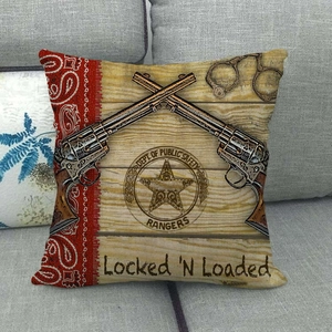 Detail of vintage cowboy linen pillowcase with revolver and star badge on sofa