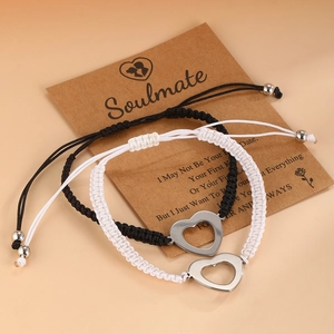 Adjustable woven couple bracelets with hollow heart charms on soulmate card