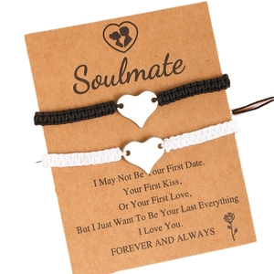 Handmade woven couple bracelets with polished stainless steel heart charms on card