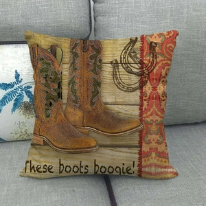 Detail of vintage cowboy boots and horseshoe print on a rustic linen pillow cover