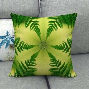 Detail of green fern leaf pattern linen cushion cover with six central metal buttons