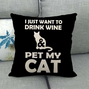 Close-up of black linen cushion cover with white cat and wine lettering detail