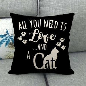 Detail of black linen pillowcase featuring white cat silhouette and cat paw prints