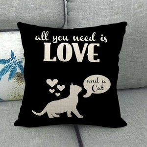 Close-up of linen cushion cover with cat silhouette and Love and a Cat text on sofa