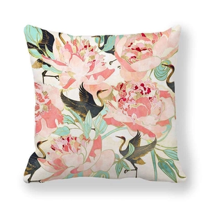 Detail of peach skin cushion cover with pink peony flowers and elegant crane print
