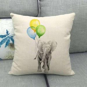 Close-up of linen cushion cover with watercolor elephant and balloons illustration