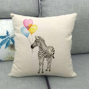 Linen cushion cover featuring zebra and heart balloons on a gray sofa background