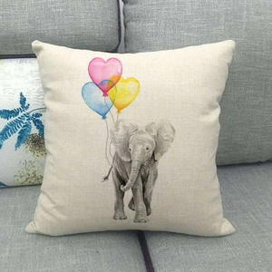 Linen cushion cover with elephant and balloon print on a minimalist sofa background