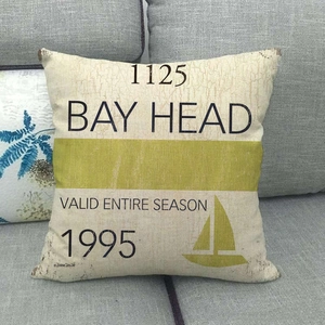 Close-up of linen cushion cover with nautical Bay Head text and yellow stripe detail