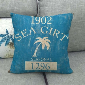 Close-up of a blue linen pillow cover with vintage yellow Sea Girt palm tree print