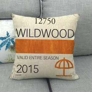 Retro linen pillowcase with Wildwood print on a grey sofa for home decor styling