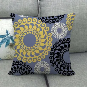 Detail of blue linen pillowcase with yellow and black abstract geometric spiral pattern