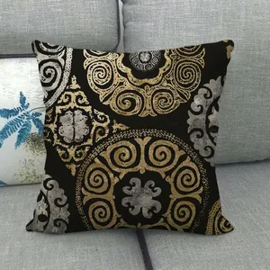 Linen pillow cover with gold and silver mandala geometric pattern on a grey sofa
