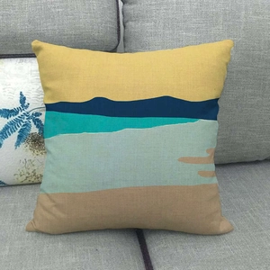 Macro detail of linen cushion cover with colorful abstract geometric landscape pattern