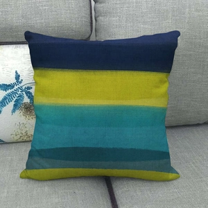 Close-up of linen cushion cover featuring navy, lime, and cyan artistic painted stripes