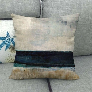 Detail shot of linen cushion cover showing cross-weave texture and blue abstract beach art