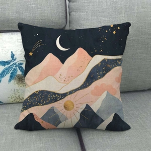Close-up of linen cushion cover featuring artistic mountain and moon landscape on a sofa
