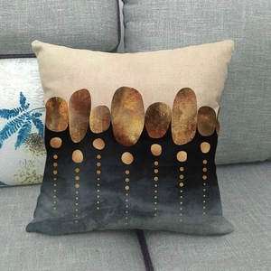 Close-up of linen pillow cover with abstract marble stone pattern on a gray sofa