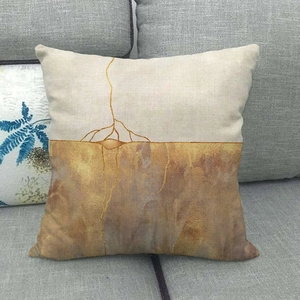 Detail of marble pattern linen cushion cover showing golden abstract mountain art texture