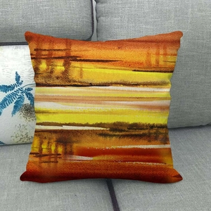 Close-up of linen cushion cover showing abstract sunset watercolor texture on sofa
