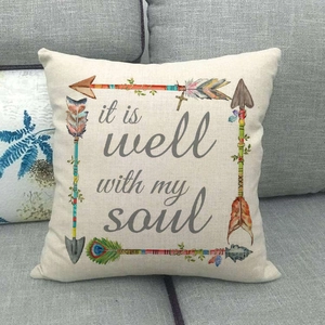 Detail of linen pillow cover with arrow feathers and 'it is well with my soul' quote
