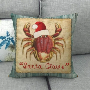 Detail of nautical Santa Claws crab pillow cover with vintage wood texture on a grey sofa