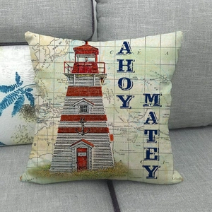Close-up of nautical lighthouse pillow case on sofa with detailed linen texture