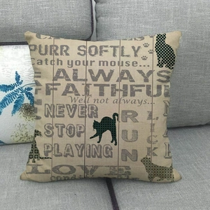 Linen square pillowcase with cat silhouette and typography on a grey sofa background