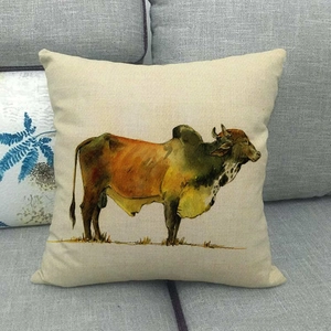 Artistic linen pillow cover with watercolor bull oil painting on a gray fabric sofa
