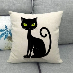 Detailed texture of square linen pillowcase with black cat print and green eyes