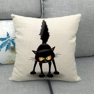Detail of cartoon cat print on a square linen pillowcase with black festive pattern