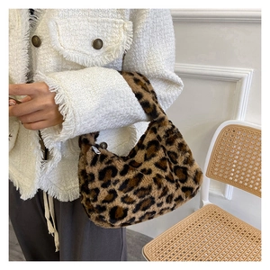 Detail showing plush leopard print faux fur texture and silver zipper on the tote bag