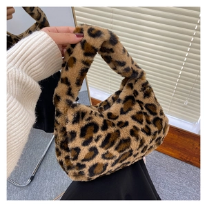 Detail of plush faux fur tote bag featuring classic leopard print pattern and sturdy handle