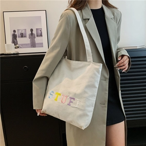 White canvas tote bag with colorful towel embroidered STUFF letters for daily casual style