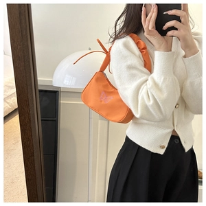 Orange hobo bag featuring pink butterfly embroidery and a stylish ruched shoulder strap