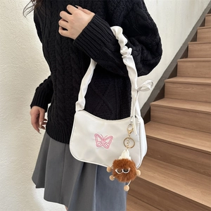 White crescent underarm bag with purple butterfly embroidery and plush charm