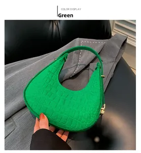 Détail du sac hobo vert avec texture crocodile embossée et ferrures dorées chic